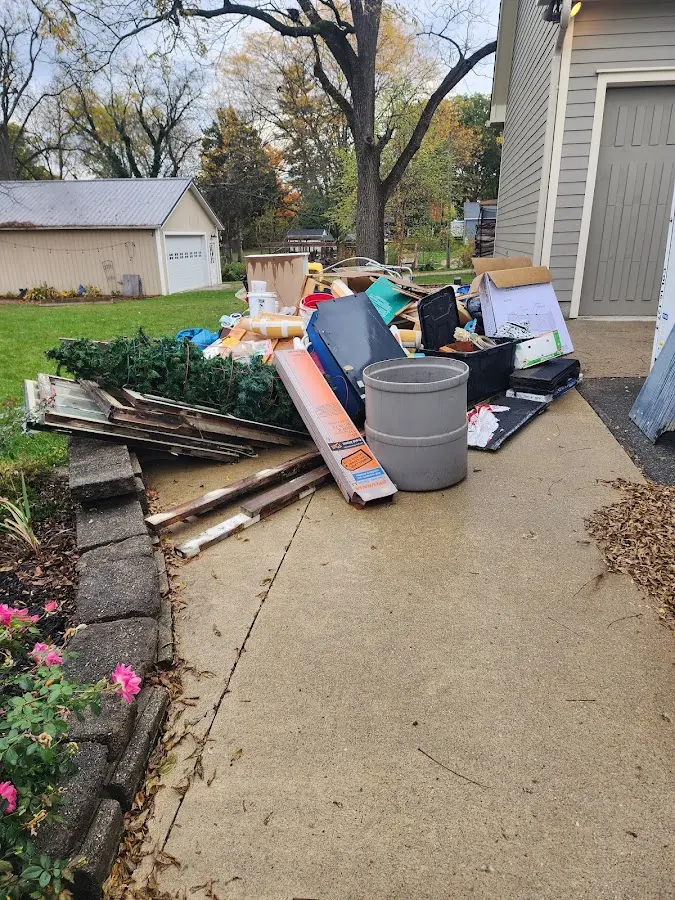 Dumpster being loaded with debris for 12 Yard Dumpster Rental in Brandywine